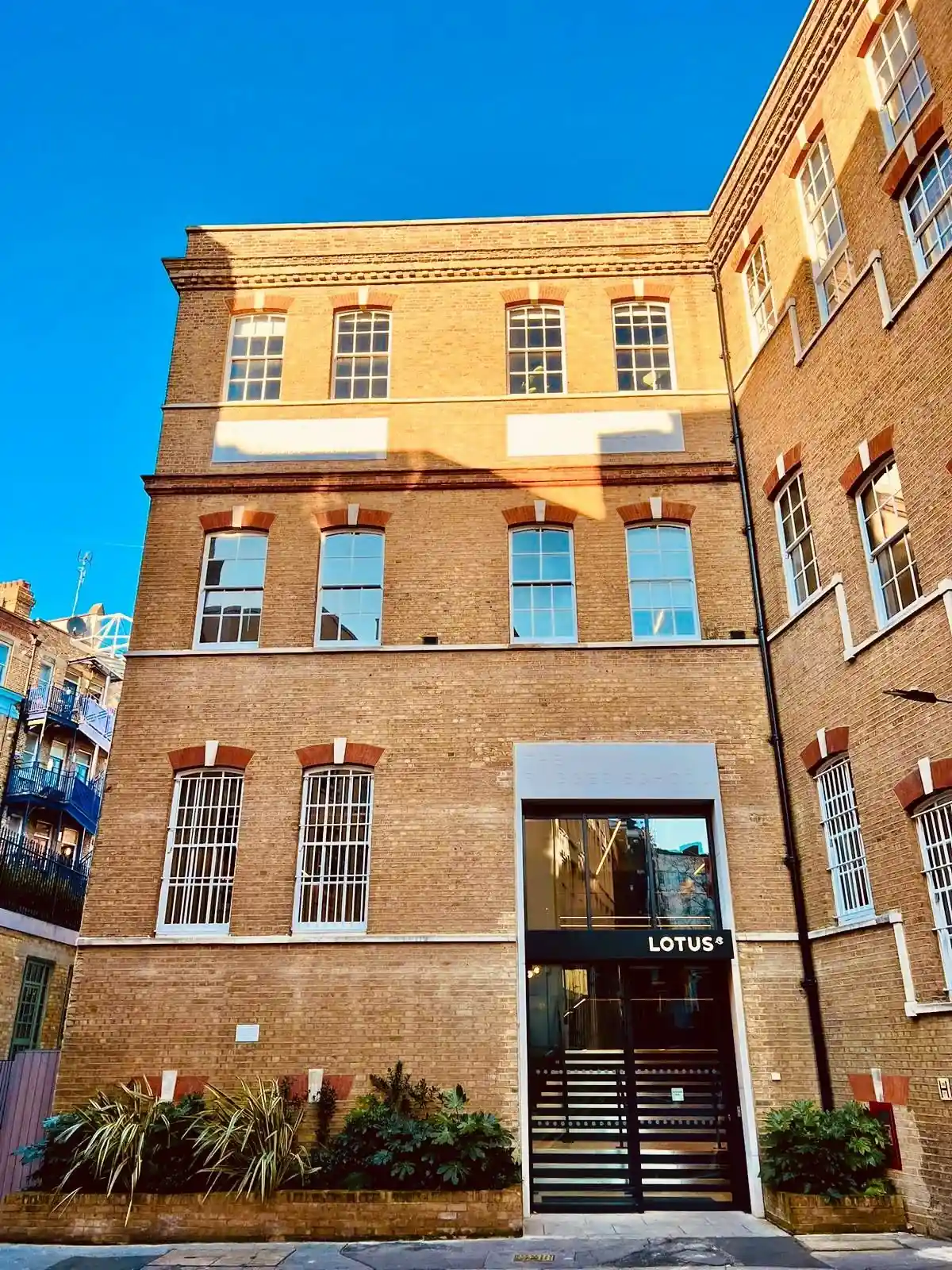 A Grade II listed stock-brick building on Vine Hill with timber sash windows