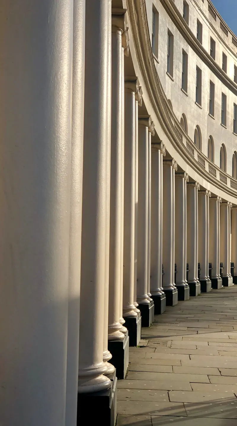 The curving colonnade of paired white columns along Park Crescent